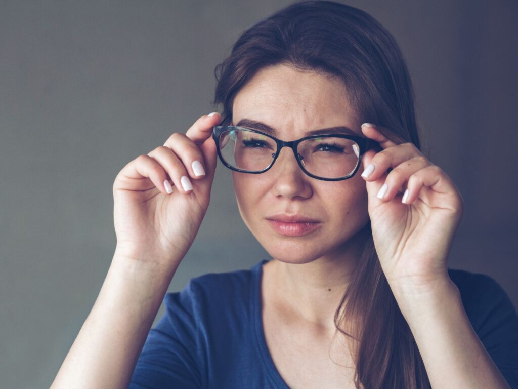 a woman squinting through eyeglasses